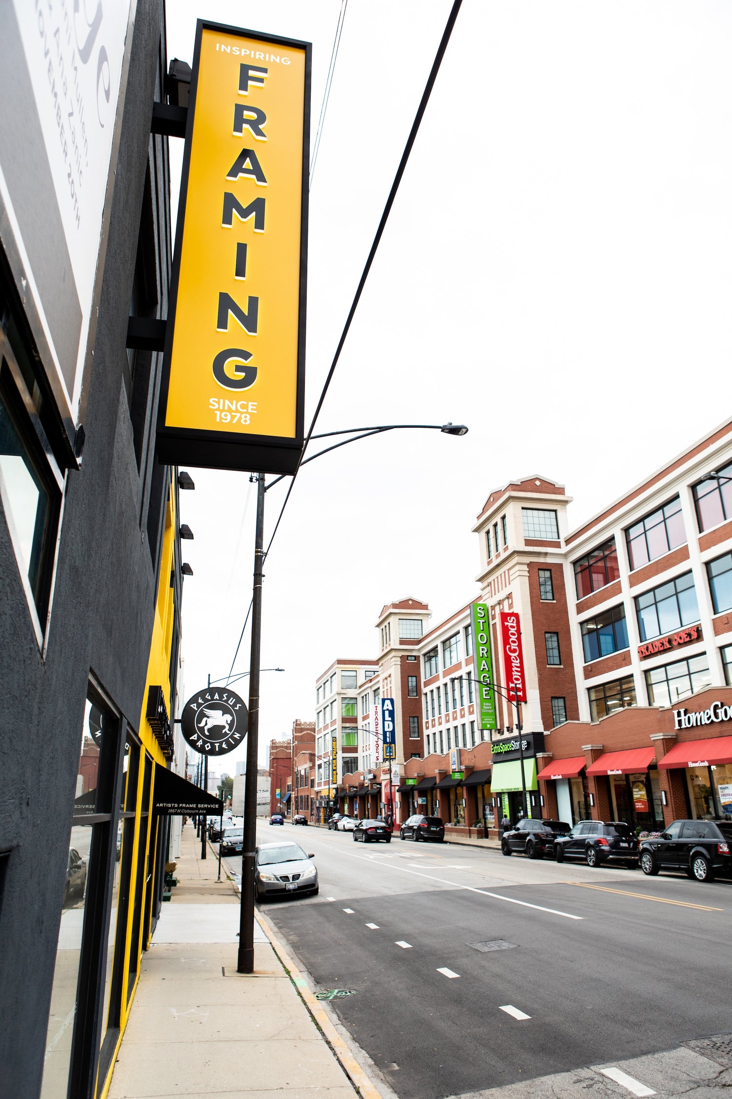 the exterior of Artist's Frame Service sign on Clybourn, with the sidewalk and street in view