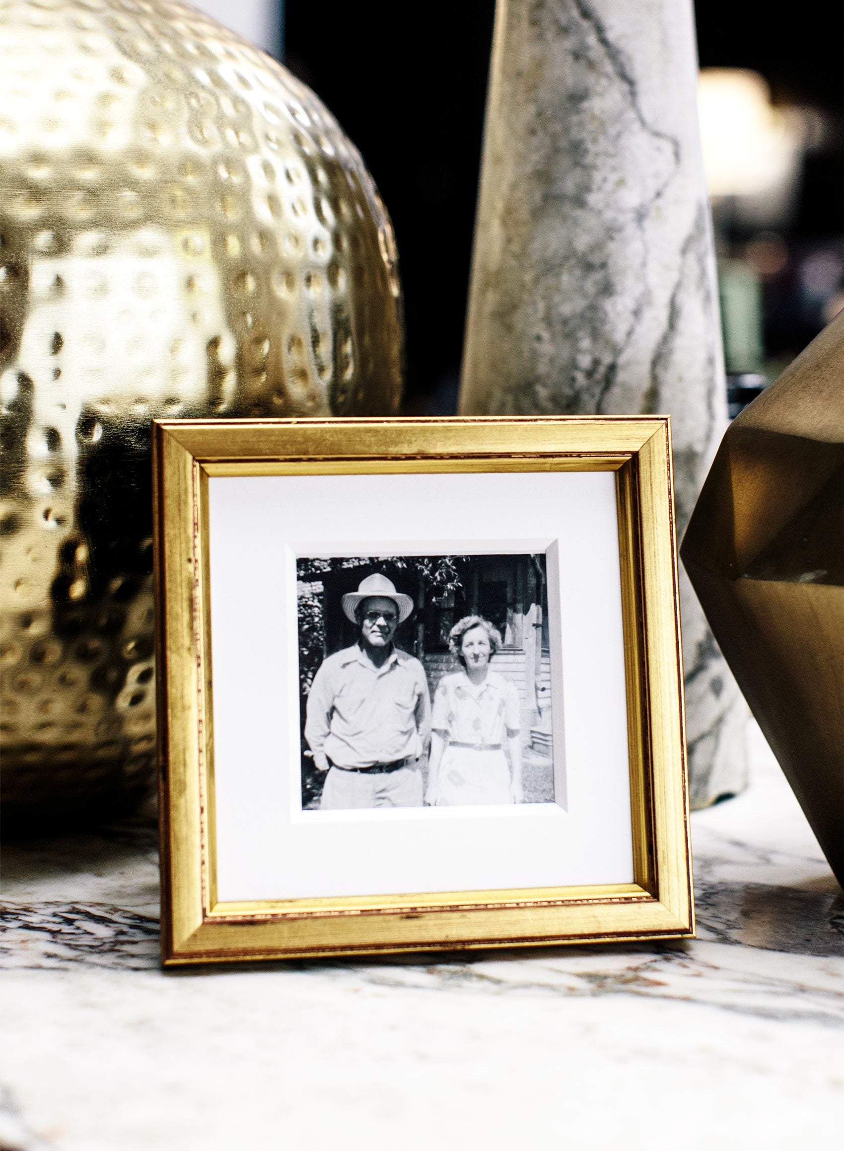 Gold Brancusi Oro Frame - Square, styled on a beautiful marble table with stone decor