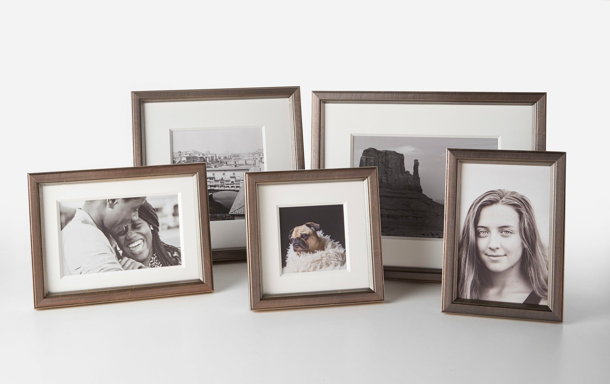 Grouped Brancui Piombo pewter-colored frames in a variety of sizes on a plain background