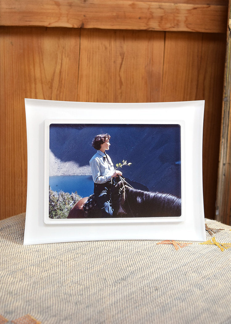 Risa Snow White frame with flared edges, inside a pretty home with a photo inside of a woman and horse